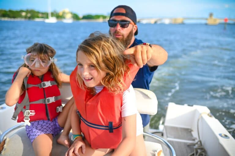 Father and 2 daughters on speed boat